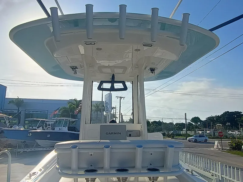 Slide: The Image of 2025 Regulator 23 boat with T-top and Garmin electronics, displayed outdoors. - 27