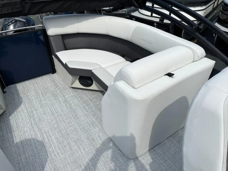 Slide: The Image of 2026 Harris Cruiser 210 boat interior with white seating and gray flooring. - 11