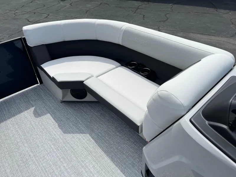 Slide: The Image of 2026 Harris Cruiser 210 boat interior with white cushioned seating and cup holders. - 12