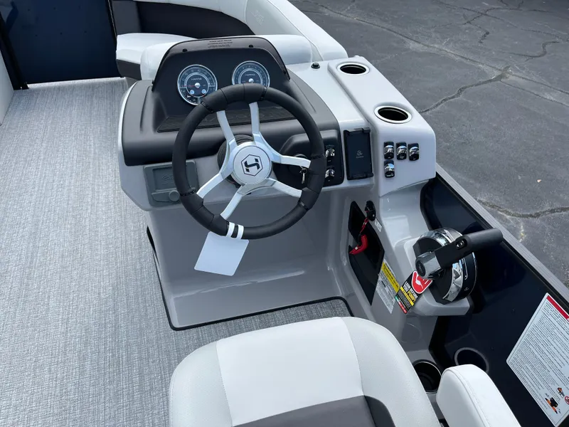Slide: The Image of 2026 Harris Cruiser 210 boat dashboard with steering wheel and controls. - 3