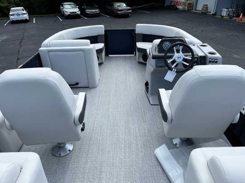 Slide: The Image of 2026 Harris Cruiser 210 boat interior with plush seating and modern steering console. - 7