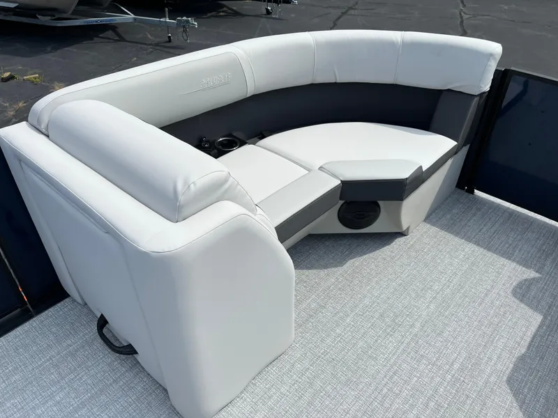 Slide: The Image of 2026 Harris Cruiser 210 boat interior with white cushioned seating and gray flooring. - 8