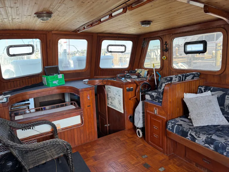 Slide: The Image of Interior of 1983 Island Trader Motor Sailor with wooden paneling and nautical decor. - 12