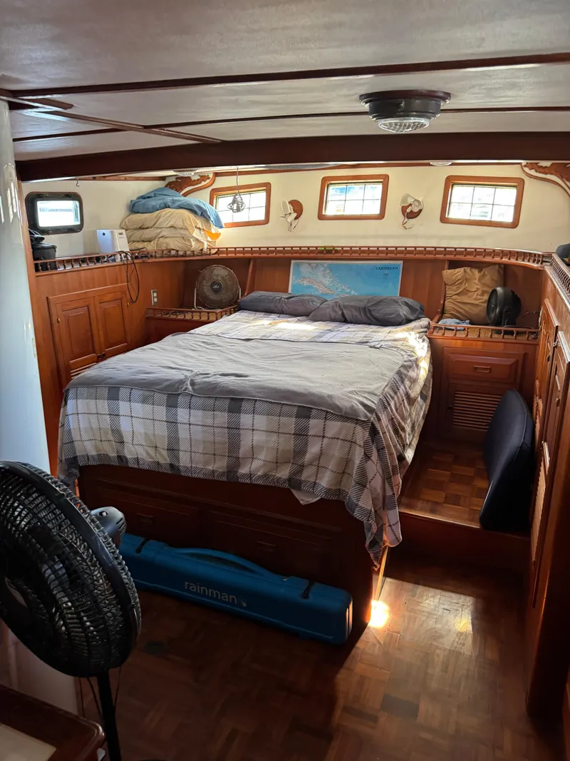 Slide: The Image of Cozy cabin interior of 1983 Island Trader Motor Sailor with bed and wooden furnishings. - 14