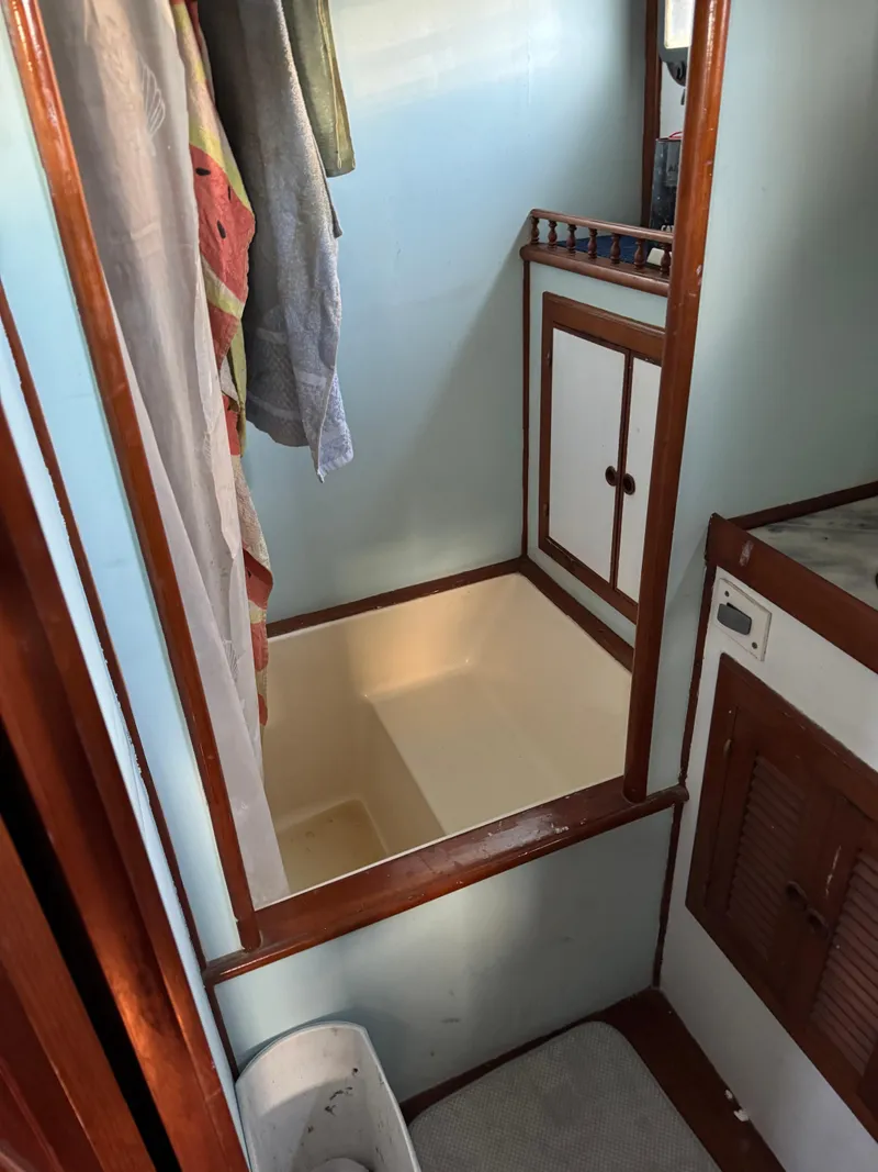 Slide: The Image of 1983 Island Trader Motor Sailor bathroom with shower and wooden cabinetry. - 15