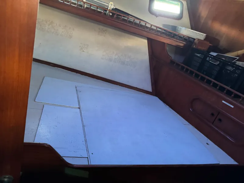 Slide: The Image of Interior cabin of 1983 Island Trader Motor Sailor with wooden finish and storage space. - 19