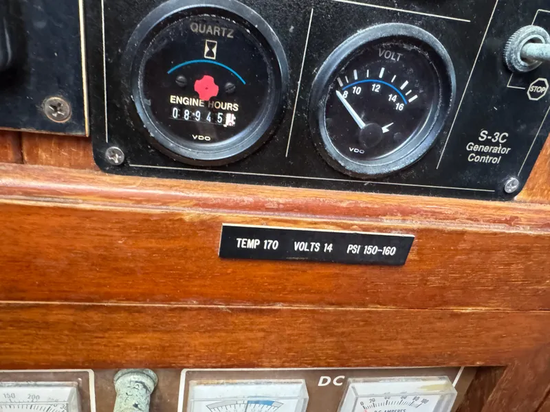Slide: The Image of Control panel of 1983 Island Trader Motor Sailor with engine hours and voltage gauges. - 20