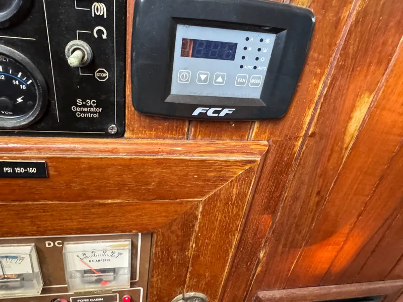 Slide: The Image of Control panel of a 1983 Island Trader Motor Sailor with gauges and switches. - 21