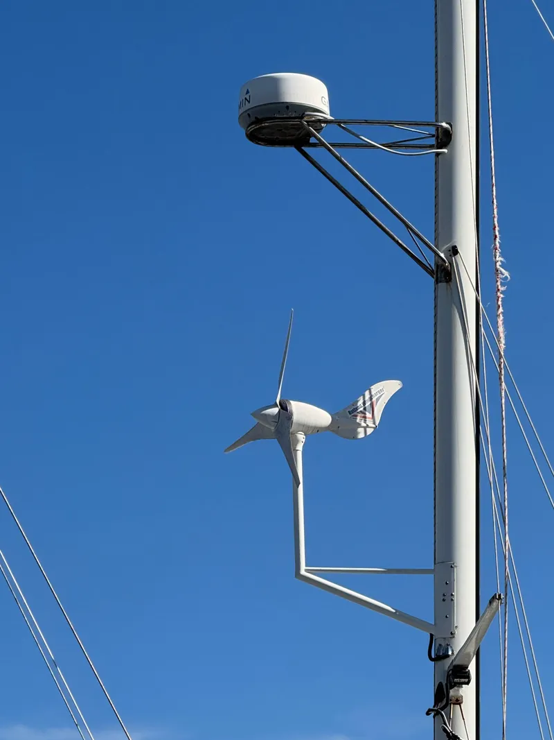 Slide: The Image of Wind turbine on Island Trader Motor Sailor mast, 1983 model, against clear blue sky. - 23