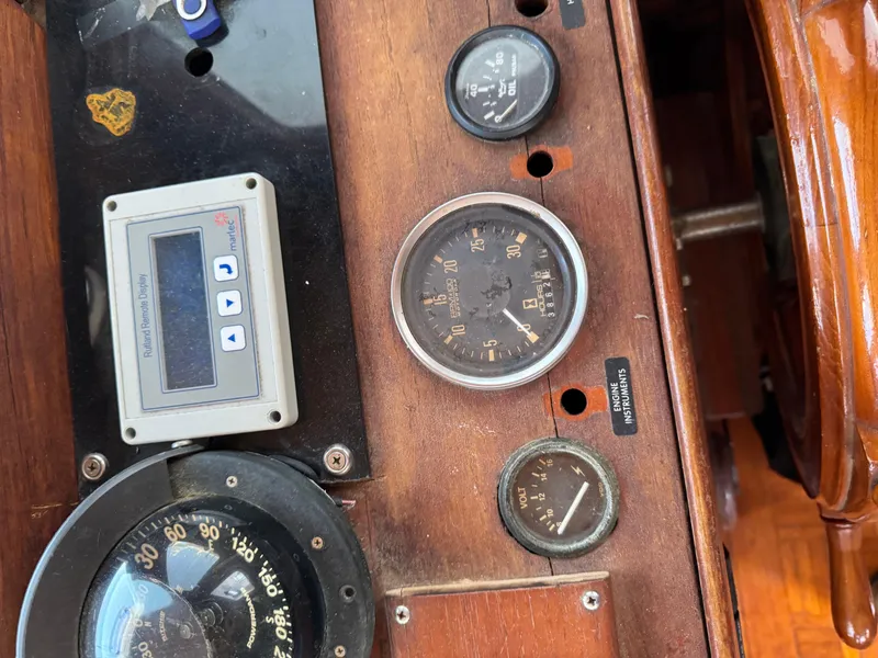 Slide: The Image of Control panel of a 1983 Island Trader Motor Sailor with gauges and navigation instruments. - 25