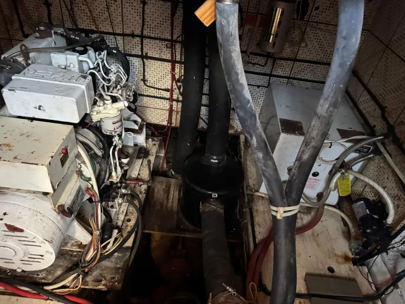 Slide: The Image of Engine room of 1983 Island Trader Motor Sailor with visible machinery and wiring. - 27