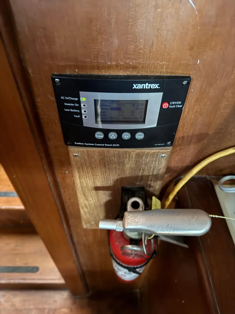 Slide: The Image of Xantrex control panel and fire extinguisher on 1983 Island Trader Motor Sailor. - 32