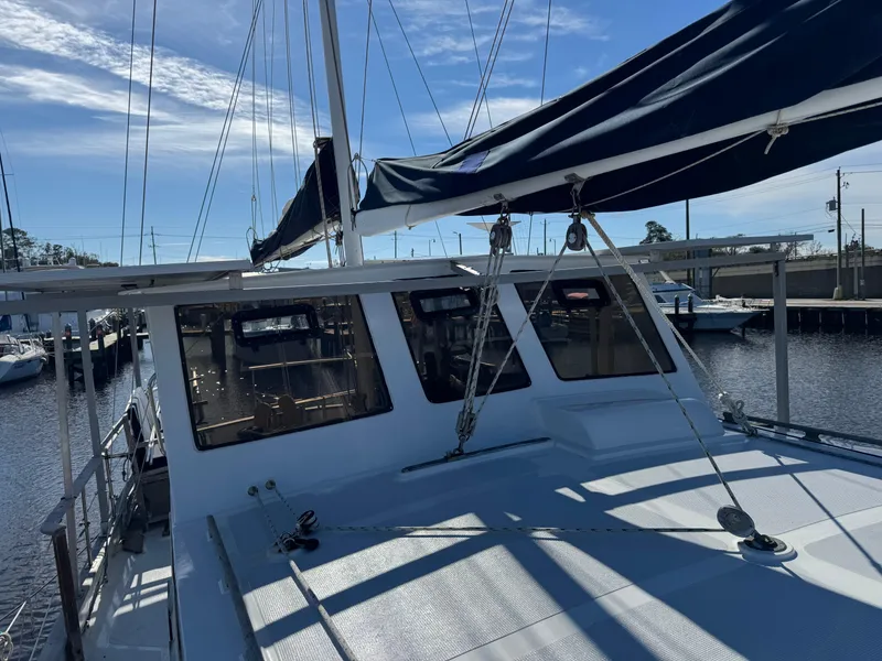 Slide: The Image of 1983 Island Trader Motor Sailor docked at marina under clear blue sky. - 5
