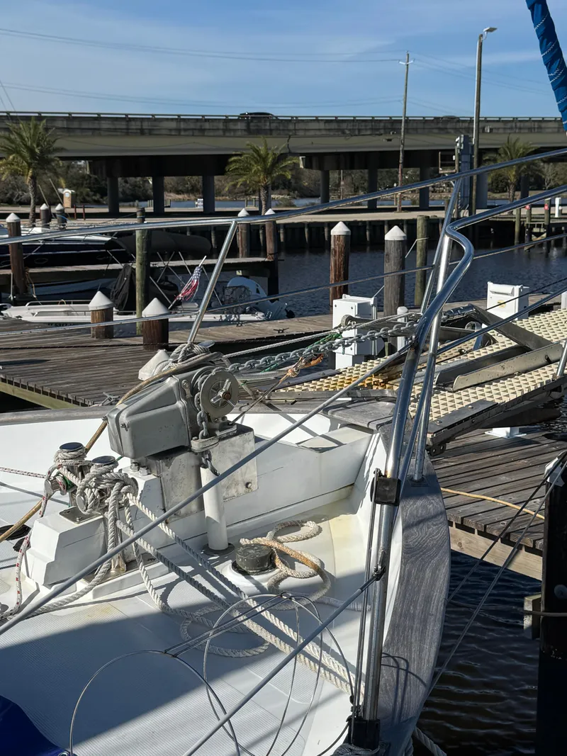 Slide: The Image of 1983 Island Trader Motor Sailor docked at marina with bridge in background. - 8