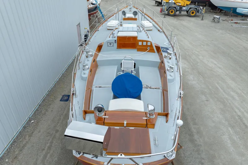 Slide: The Image of 1972 Hinckley 48 yacht in dry dock, showcasing deck and equipment. - 13