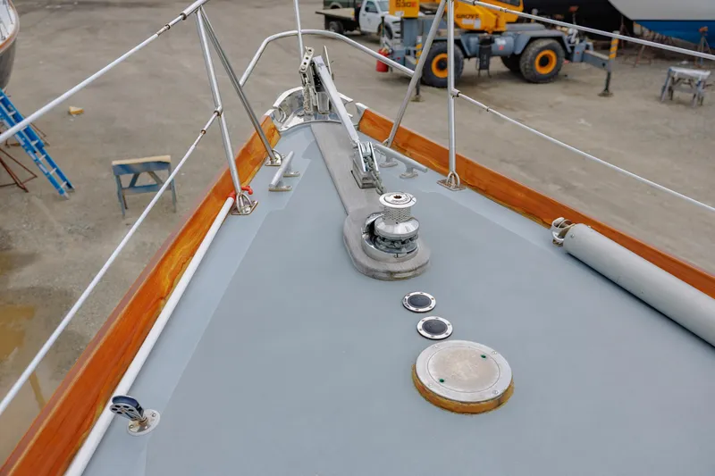 Slide: The Image of Bow of a 1972 Hinckley 48 yacht with deck fittings and winch. - 16