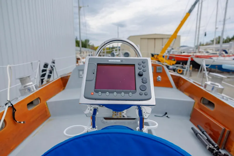 Slide: The Image of Cockpit of 1972 Hinckley 48 sailboat with navigation equipment, docked in a marina. - 21