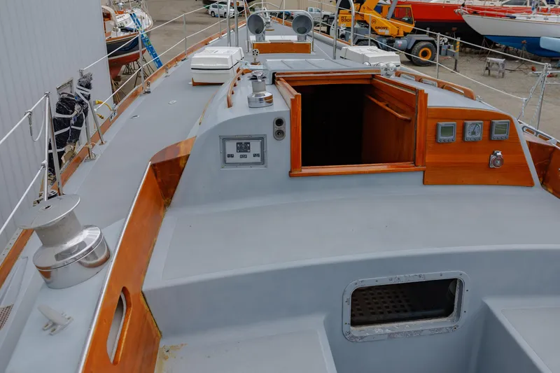 Slide: The Image of Hinckley 48 sailboat deck, 1972 model, featuring wooden accents and nautical equipment. - 23