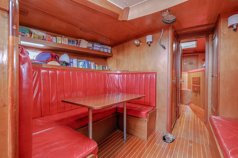 Slide: The Image of Interior of 1972 Hinckley 48 yacht with red leather seating and wooden finishes. - 38