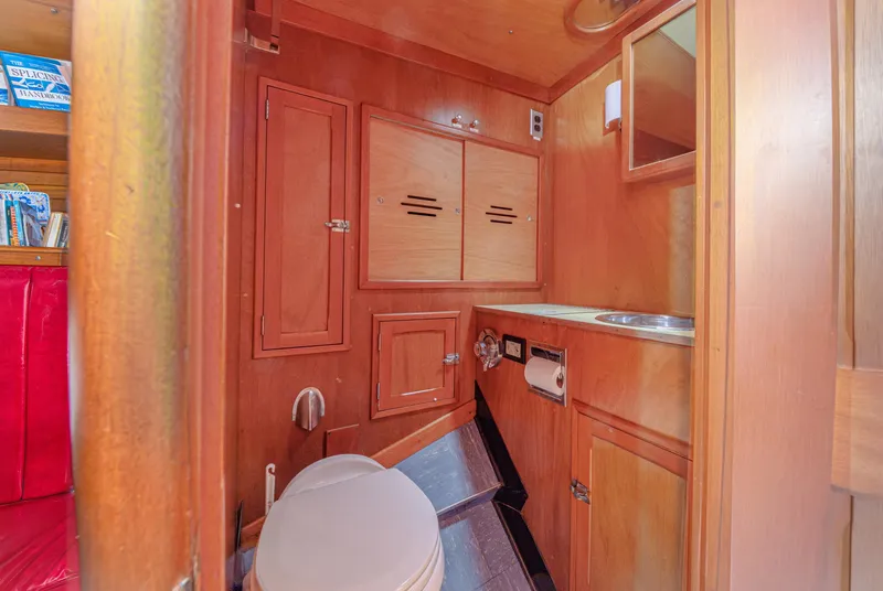 Slide: The Image of Interior of 1972 Hinckley 48 yacht bathroom with wooden cabinetry and compact design. - 44