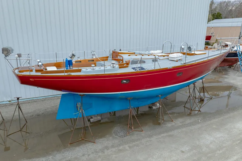 Slide: The Image of 1972 Hinckley 48 sailboat with red hull and blue keel on stands. - 5