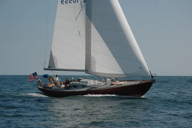 The Image of Hinckley 48 sailboat from 1972 sailing on open water with American flag. - 0