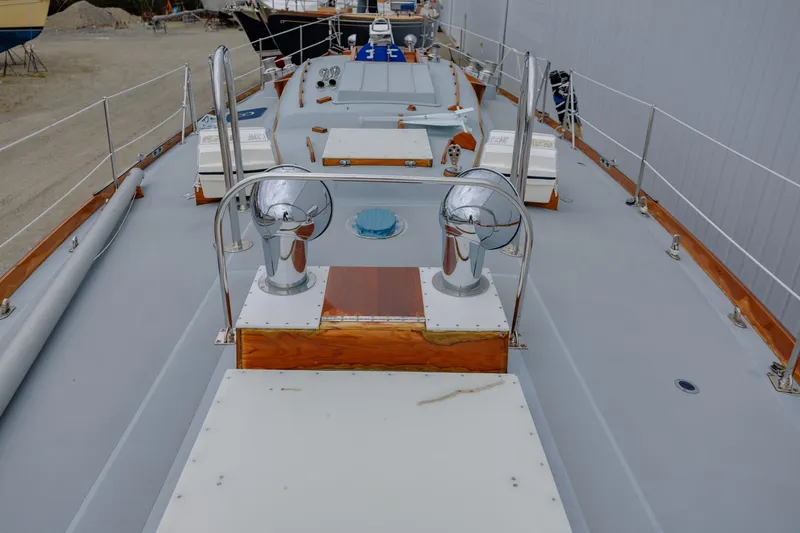 Slide: The Image of Hinckley 48 yacht deck, 1972 model, featuring polished metal fixtures and wooden accents. - 17