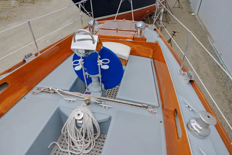 Slide: The Image of Hinckley 48 sailboat deck, 1972 model, featuring polished wood and nautical equipment. - 18