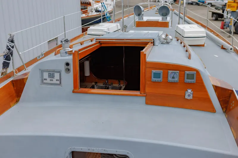 Slide: The Image of 1972 Hinckley 48 sailboat deck with open hatch and navigation instruments. - 26