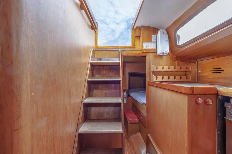 Slide: The Image of Interior of 1972 Hinckley 48 sailboat with wooden stairs and cozy cabin. - 30