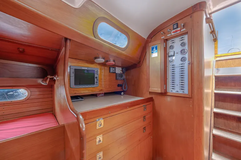 Slide: The Image of Interior of 1972 Hinckley 48 sailboat with wooden cabinetry and navigation equipment. - 31