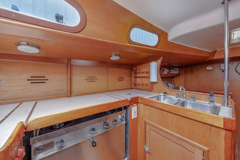 Slide: The Image of Interior of 1972 Hinckley 48 yacht kitchen with wooden cabinetry and stainless steel sink. - 37