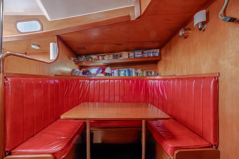 Slide: The Image of Interior of 1972 Hinckley 48 yacht with red leather seating and wooden table. - 39
