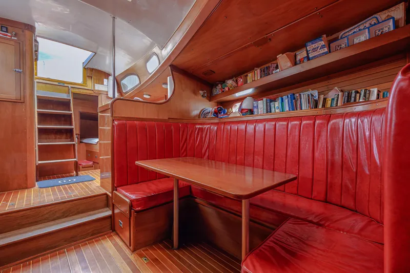 Slide: The Image of Interior of 1972 Hinckley 48 yacht with red leather seating and wooden finishes. - 40