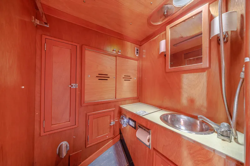 Slide: The Image of Interior of 1972 Hinckley 48 yacht bathroom with wooden cabinetry and stainless steel sink. - 43