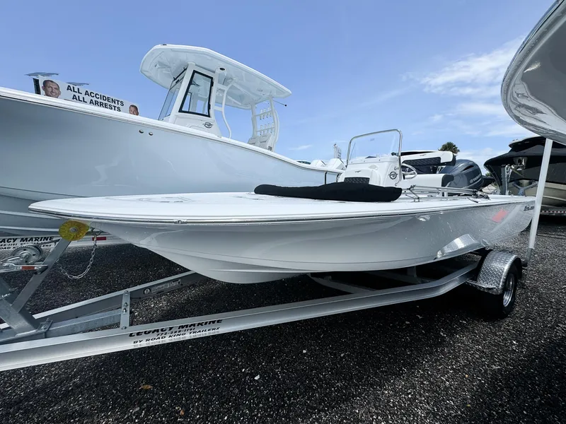 The Image of 2026 Tidewater 1910 Bay Max boat on trailer, displayed outdoors under clear sky. - 0