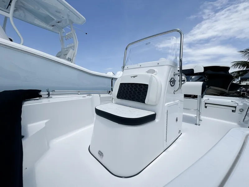 Slide: The Image of 2026 Tidewater 1910 Bay Max boat interior with seating and console under clear blue sky. - 4