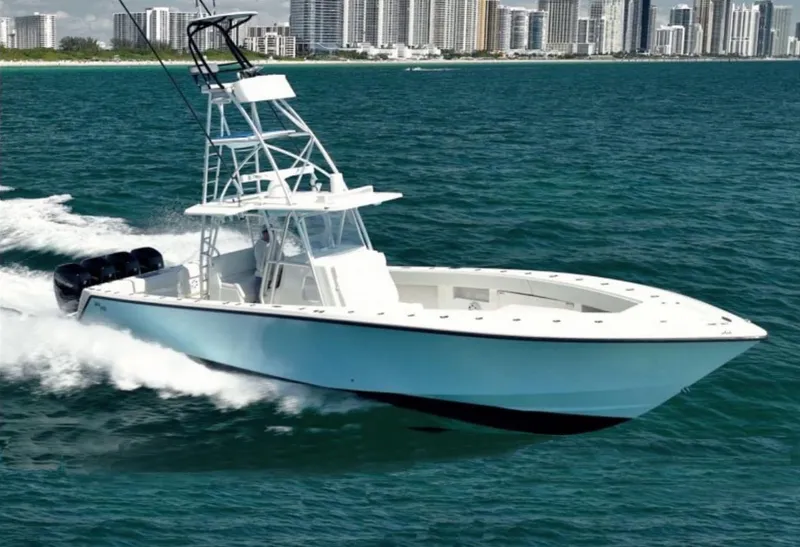 Slide: The Image of 2018 SeaVee 390Z boat cruising on ocean with city skyline in background. - 0