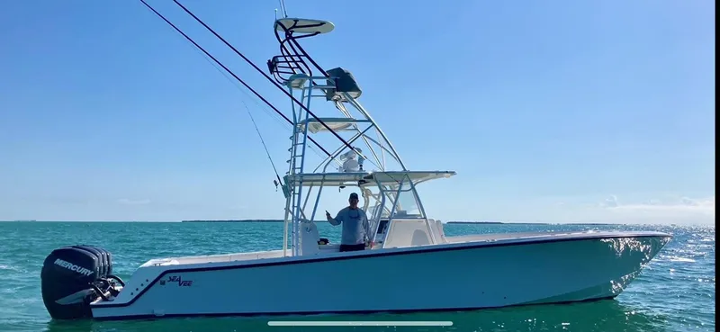 Slide: The Image of 2018 SeaVee 390Z boat on calm ocean waters under clear blue sky. - 1