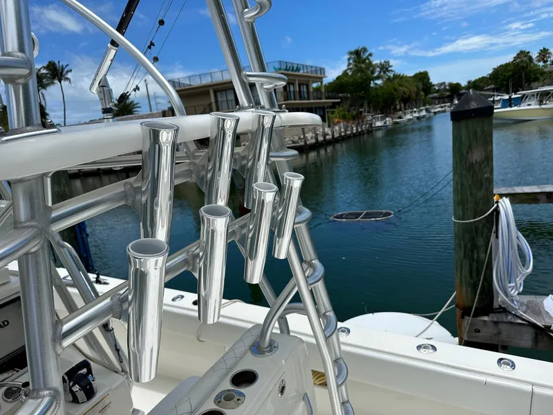 Slide: The Image of 2018 SeaVee 390Z boat with rod holders, docked by a serene waterfront. - 12