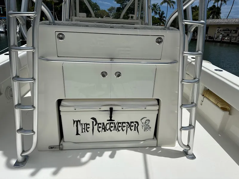 Slide: The Image of 2018 SeaVee 390Z boat interior with "The Peacekeeper" cooler, ladder, and storage compartments. - 17