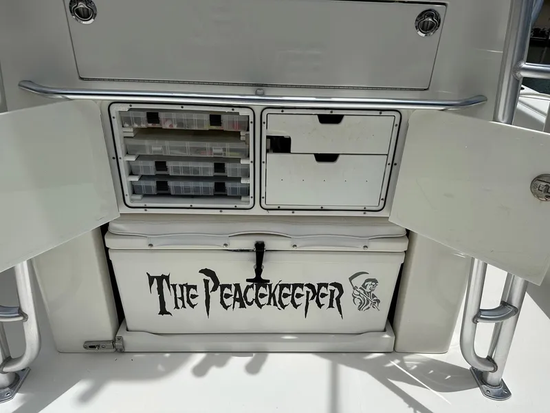 Slide: The Image of 2018 SeaVee 390Z boat storage with "The Peacekeeper" label and open compartments. - 18