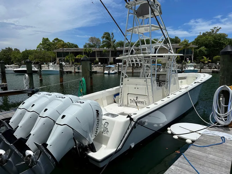 Slide: The Image of 2018 SeaVee 390Z boat docked, featuring multiple Mercury outboard engines, in a marina setting. - 25