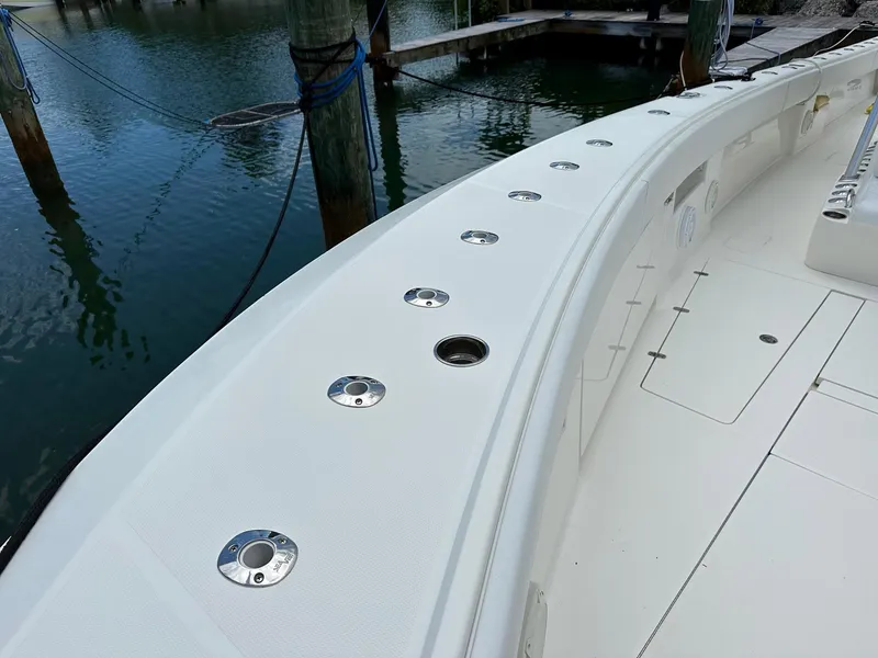 Slide: The Image of 2018 SeaVee 390Z boat deck with rod holders, docked by the water. - 4