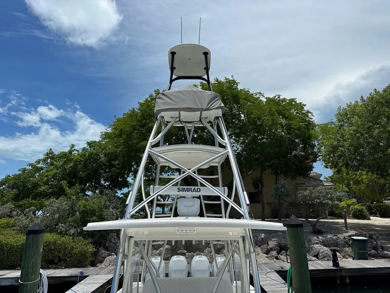 Slide: The Image of 2018 SeaVee 390Z boat with tower docked under a partly cloudy sky. - 6