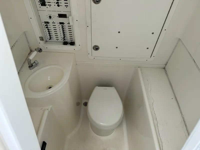 Slide: The Image of Compact bathroom in 2018 SeaVee 390Z boat with toilet, sink, and control panel. - 7