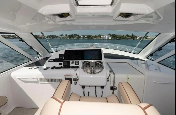 Slide: The Image of Helm of 2015 Hatteras 45 Express Sportfish with modern controls and panoramic view. - 14