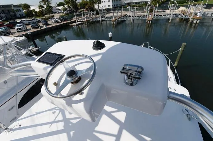 Slide: The Image of Helm of 2015 Hatteras 45 Express Sportfish overlooking marina. - 27
