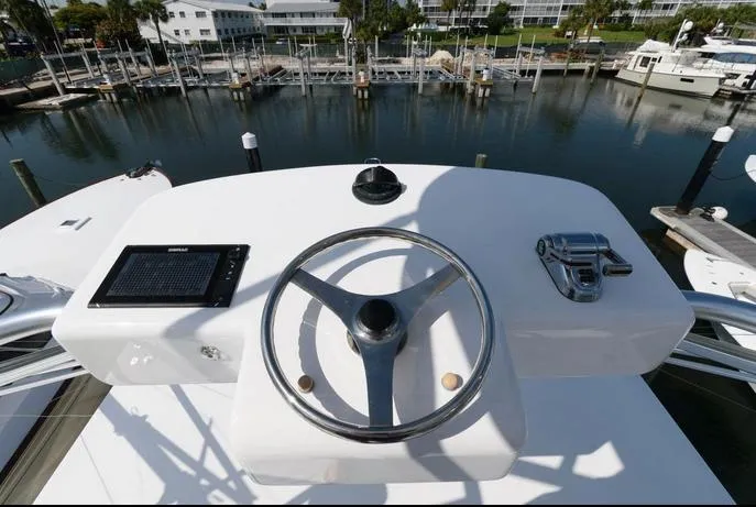 Slide: The Image of Helm of 2015 Hatteras 45 Express Sportfish overlooking marina. - 28