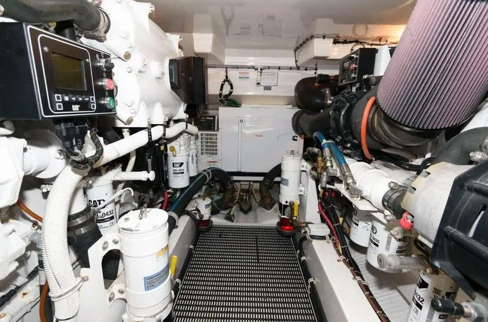 Slide: The Image of Engine room of 2015 Hatteras 45 Express Sportfish, showcasing mechanical components and equipment. - 31